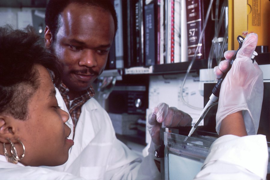 Two Black lab scientists running a test with a pipette